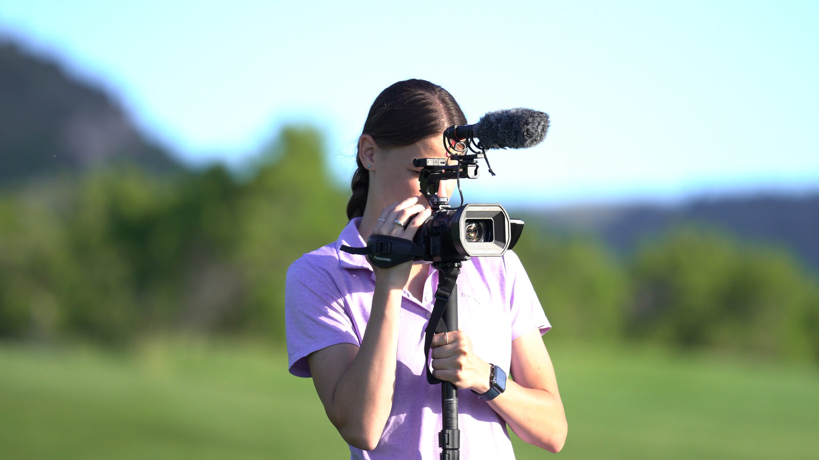 Birdie Film Co. videographer filming with a camera on the golf course